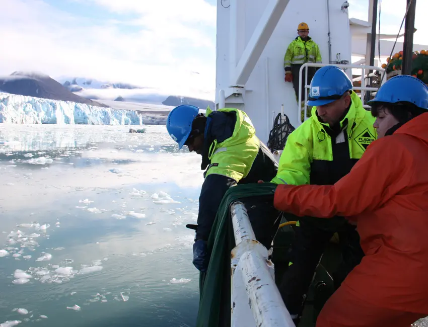Hauling of zooplankton net in front of glacier
