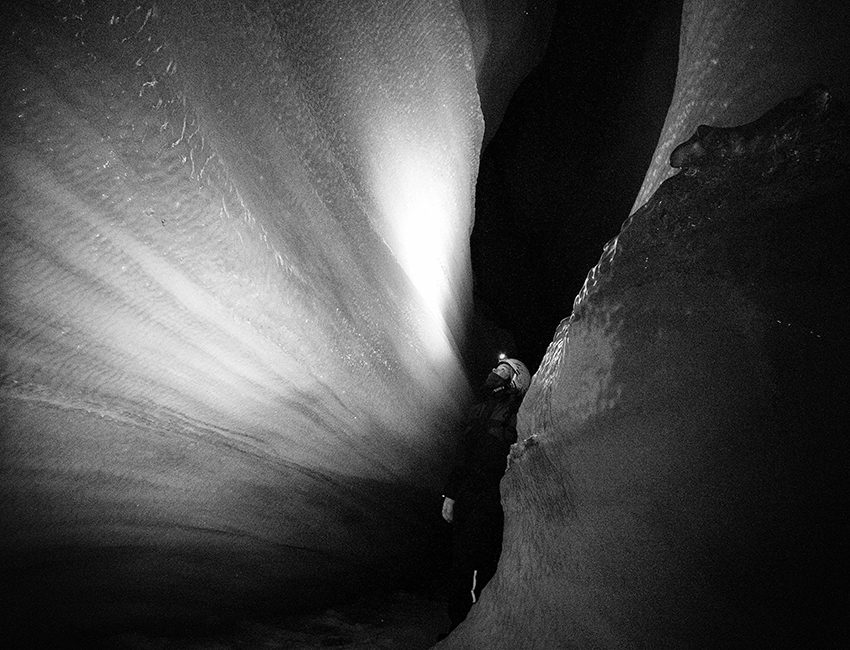 Inside a melting channel in the glacier Longyearbreen. Melting glaciers feed minerals to marine and terrestrial ecosystems. Photo: Mads Forchhammer/UNIS